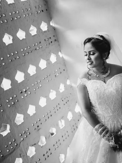 A beautiful black and white bridal portrait using patterned light from a wall. This creative use of light adds texture and interest to the shot.