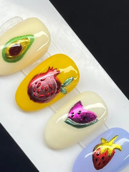 A close-up of our chrome fruit designs, including an avocado, pomegranate, watermelon, and strawberry.
