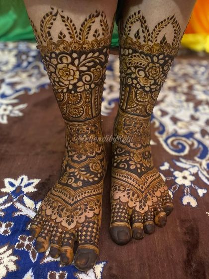 This design takes courage and creativity. It features bold, dark floral patterns that create a powerful contrast, covering the feet in a rich tapestry of henna.