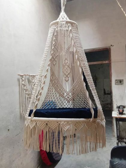 A beautiful sofa swing with a unique design, seen here in our workshop. This piece is ready to be shipped to a new home, bringing comfort and style.