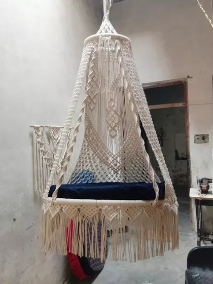A beautiful sofa swing with a unique design, seen here in our workshop. This piece is ready to be shipped to a new home, bringing comfort and style.