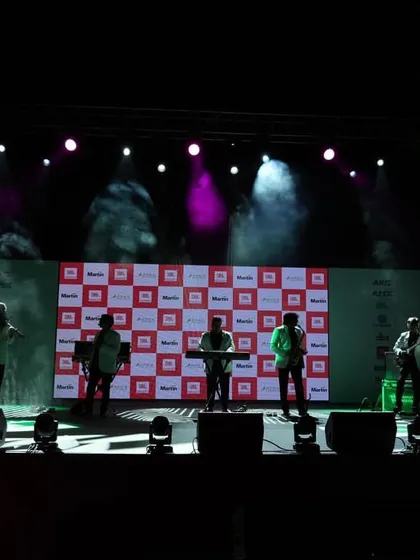 A live band performance under full stage lighting at a corporate event. We use professional lighting and effects to create a dynamic and engaging experience for attendees.