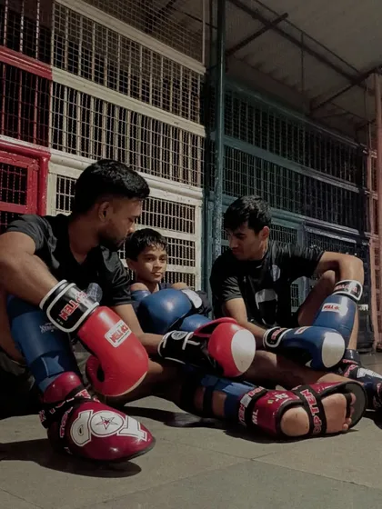 The bond between a coach and student is built on trust and hard work. Here, our students engage in a kickboxing drill, learning from experienced coaches who have shaped national and international champions.