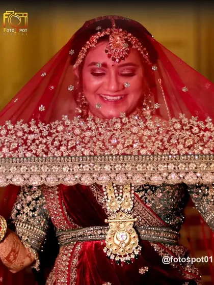 Every bride deserves to feel like royalty. I use creative lighting and angles to create stunning bridal portraits that are both elegant and full of emotion, like this classic shot of a bride's shy smile from behind her veil.