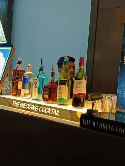 A view of the bar top with a full range of spirits and a custom digital menu.