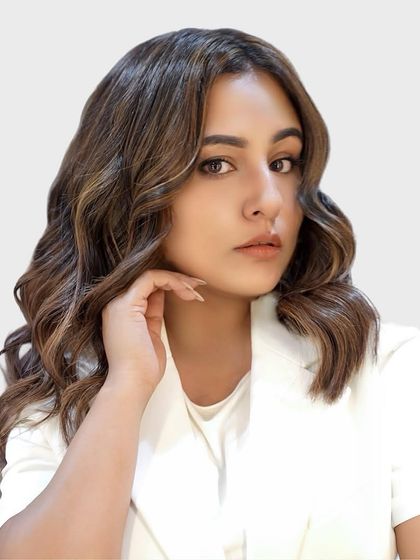 A portrait of our client enjoying her new caramel brown hair color, achieved with ammonia-free L'Oréal iNOA for incredible shine and softness.