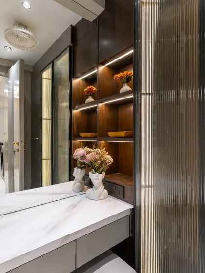 Step into a world where elegance meets everyday ease. This walk-in wardrobe, wrapped in rich walnut veneer, is a true sanctuary for style lovers, offering generous space for clothing and accessories.