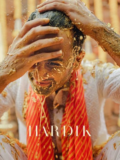 A close-up of the groom's face during the Haldi, a moment of pure, messy joy.