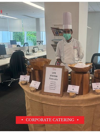 We bring our live stations to any venue, including corporate offices. Here is our live pancake station, complete with toppings like maple syrup and whipped cream, ready to serve a delicious breakfast.