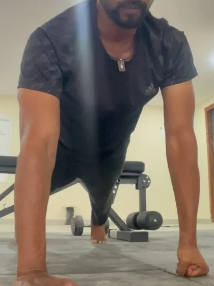 The top of a fist pushup, demonstrating shoulder and wrist stability. This is functional strength that translates to many other movements.
