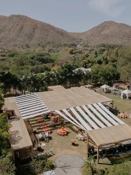 Another aerial shot of the 'Rajasthani Folklore' Mehendi, capturing the entire layout against the stunning mountain backdrop.