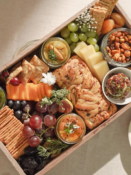 Our Cheese & Dip Grazing Box, a perfect example of our 'Easy Dining' home delivery service. This curated selection includes artisanal cheeses, freshly baked breads, seasonal fruits, nuts, and our signature dips, designed for effortless and elegant hosting at home.