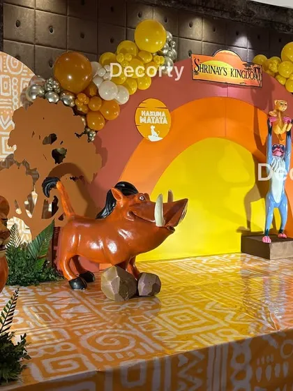A side view of the stage, featuring life-sized statues of Mufasa, Pumbaa, and Timon, bringing the beloved characters to life.