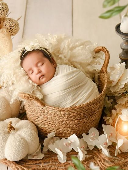 A wider angle of the all-white rustic theme, showing the full arrangement of pumpkins, candles, and flowers that create this beautiful scene.