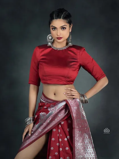 A confident three-quarter portrait of the Indo-western saree concept. The focus is on the model's strong presence and the bold combination of traditional and modern elements.