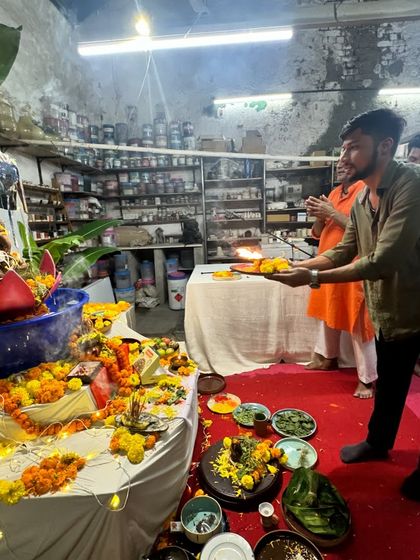 Another member of our studio family offers the aarti thali to the Ganesha idol. Everyone gets a chance to participate in the puja, making the experience personal and meaningful.