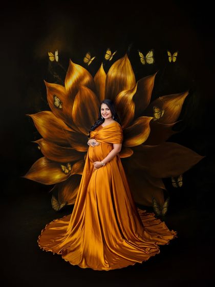 A portrait fit for a queen. The addition of a painted floral backdrop and delicate butterflies transforms this shot into a piece of fine art, celebrating the life-giving energy of motherhood.