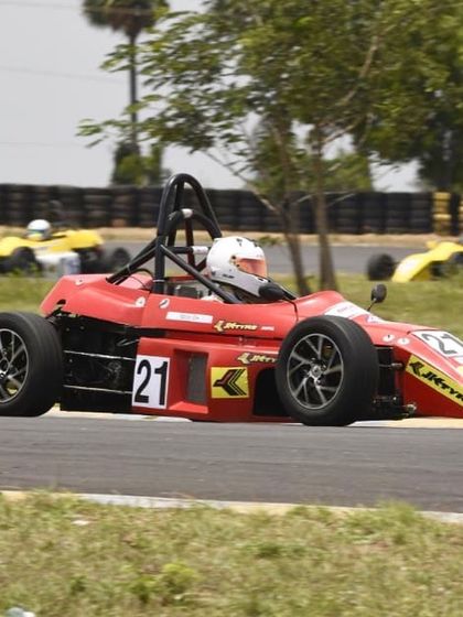 Our driver in the number 21 car, focused on the track ahead with competitors visible in the background.