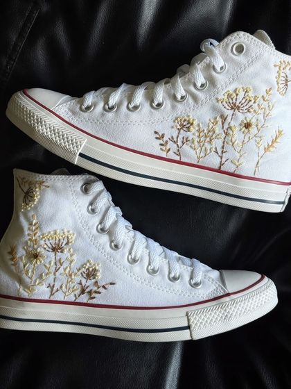 A top-down view of the embroidered Converse high-tops.