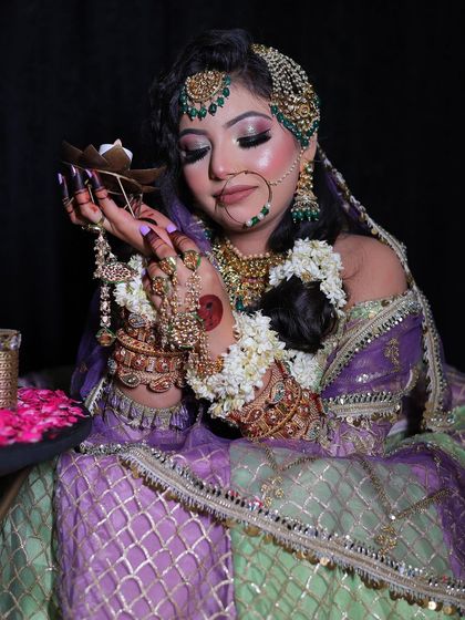 This shot showcases the detailed hand jewellery and the rich texture of the lehenga. It's a look that is full of intricate details and old-world charm.