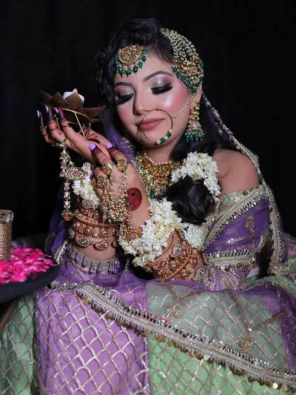 This shot with a diya highlights the soft, romantic feel of the mint and lavender lehenga, making it perfect for an evening function.
