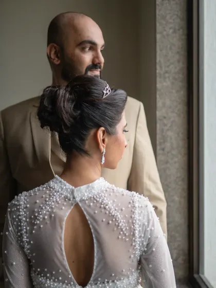 A creative shot focusing on the beautiful detail of the bride's dress. This artistic wedding portrait captures a different perspective of the couple's special moment.