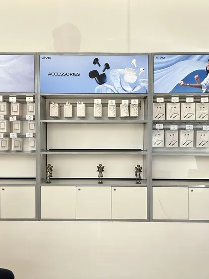 The completed accessories wall at the Vivo showroom in Ahmedabad. The design uses backlighting and clean shelving to make the products stand out.