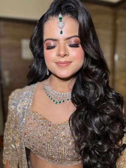 A stunning engagement bride dolled up by my team artist Sunaina. The glittery eye makeup and voluminous curls are perfect for a glamorous event.