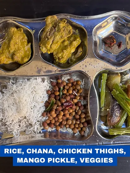 A typical Indian thali: rice, chana, chicken thighs, mango pickle, and vegetables. Balanced, traditional, and delicious.