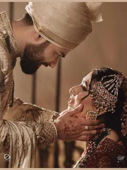 A tender moment between the bride and groom. This close-up captures the emotion of the day and the beautiful details of their wedding attire.