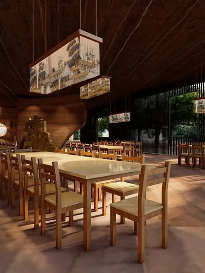 The dining area within the Elephant Pavilion is designed for communal gathering. The open layout, simple timber furniture, and custom hanging lights create a functional space that feels connected to the surrounding forest, with materials that are honest and durable.