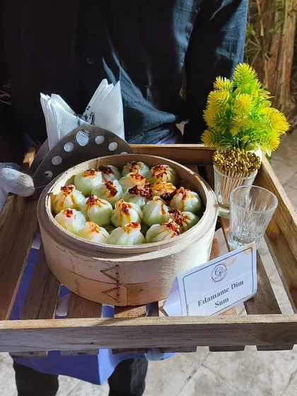 Dim sum and good company make for the perfect feast. Here, our Edamame Dim Sum is served fresh from a rustic wooden tray.
