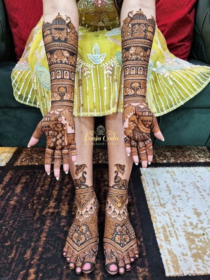 A full hands and feet mehendi for an NRI bride from the US, featuring classic elephant and peacock motifs for a timeless and elegant bridal look.