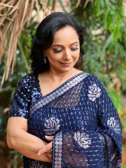 A candid, serene moment in a garden, the natural light highlighting her radiant skin.