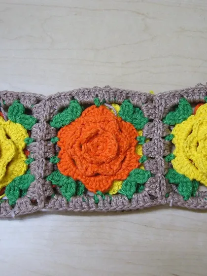 A strip of the rose granny squares before being assembled into the basket.