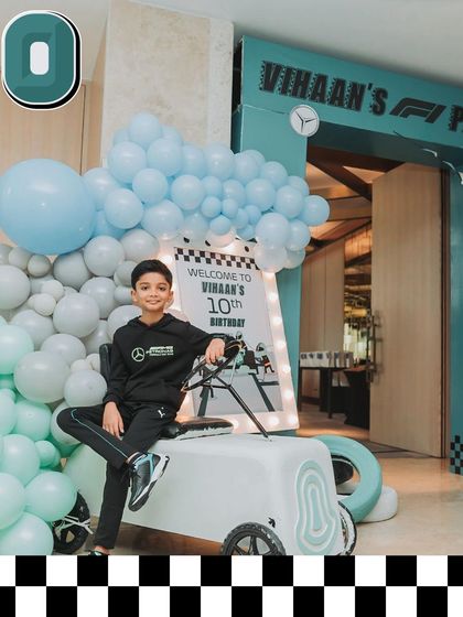 Vihaan makes a grand entrance at his F1 party, seated on a custom-built miniature vintage car. Entrances are a key part of the story I create for the guest of honor.