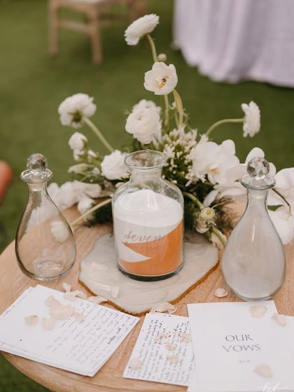 The sand ceremony setup, where the couple poured two different colors of sand into a single jar to symbolize their union.