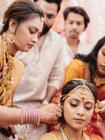 A touching moment of family helping the bride with her earrings. These getting-ready shots are full of love and anticipation.