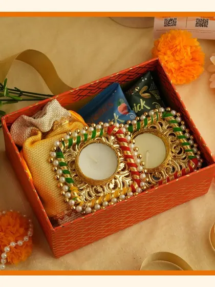 Brighten up your celebrations with our vibrant orange Navratri and Diwali hampers, filled with small treats and decorative diyas.