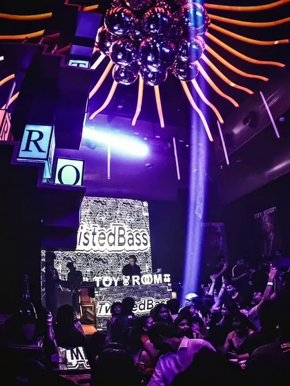 The unique setup at Toy Room, Pune, with its signature branding and lighting, provides an amazing backdrop for a high-energy DJ set.
