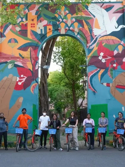 A group shot in front of one of the most vibrant and detailed murals in the Lodhi Art District. It's the perfect souvenir from an art-filled day.