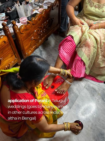The application of Parani (or Altha), a traditional red dye, on the bride's feet, a significant ritual in both Telugu and Bengali cultures.