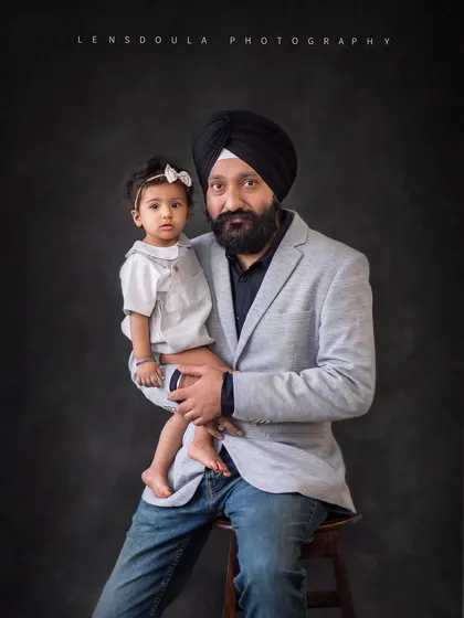 A strong and loving portrait of a father and his daughter. The pride and affection in his eyes are beautifully captured.