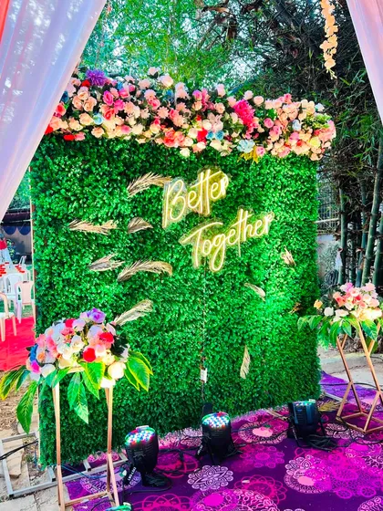 The 'Better Together' photo booth, viewed from a different angle, showcasing the colorful floral arrangements.