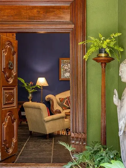 An antique wooden door and a stone Buddha statue mark the entrance to one of our suites, creating a serene and spiritual ambiance.