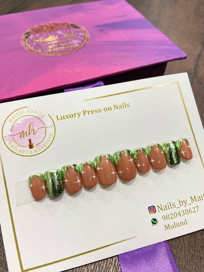 A custom press-on set with a unique green and brown design, accented with glitter. This shows the range of color combinations I can work with.