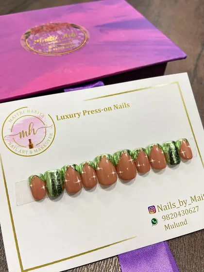 A custom press-on set with a unique green and brown design, accented with glitter. This shows the range of color combinations I can work with.