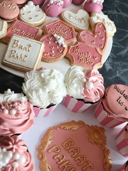 A closer look at the variety in my "Baat Pakki" dessert platter, showing the intricate piping on the cupcakes and the detailed cookie designs.