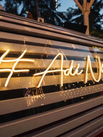 A custom neon sign featuring the couple's wedding hashtag. This modern detail served as a cool, personalized backdrop for the Sangeet stage and a great photo spot for guests.