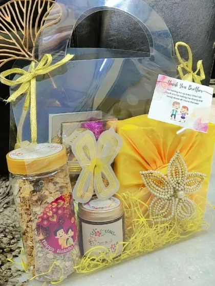 A full view of the yellow-themed transparent Rakhi gift bag.